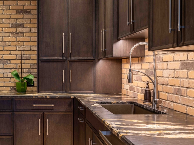Wooden kitchen cabinets with black countertops